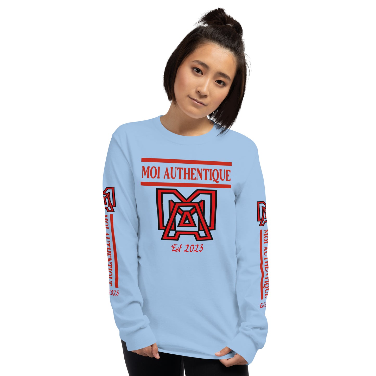 A woman wearing a long-sleeved blue shirt with red text and graphics, including the brand name 'Moi Authentique' across the chest.