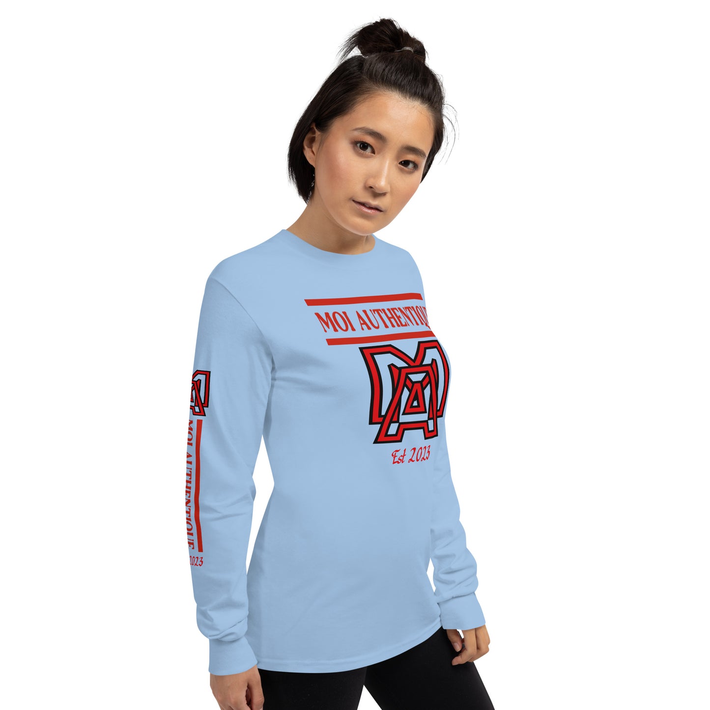 Side-on view of a woman wearing a long-sleeved blue shirt with red text and graphics, including the brand name 'Moi Authentique' across the chest