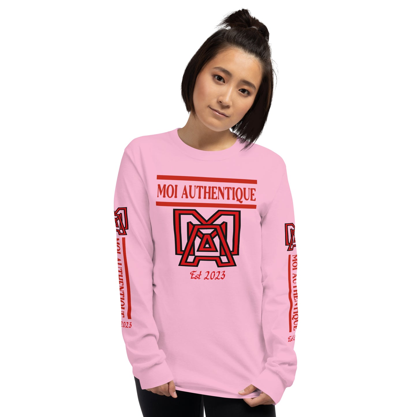 A woman wearing a long-sleeved pink shirt with red text and graphics, including the brand name 'Moi Authentique' across the chest.