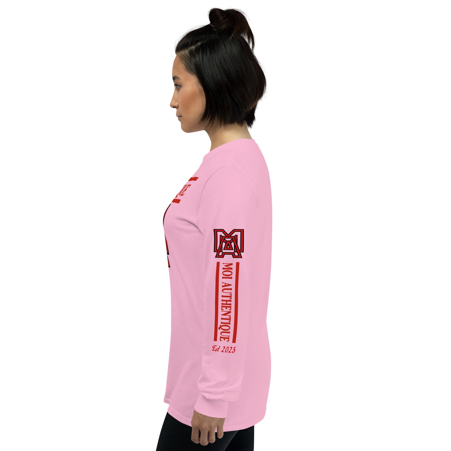 Left side view of a woman wearing a long-sleeved pink shirt with red text and graphics, including the brand name 'Moi Authentique' across the chest