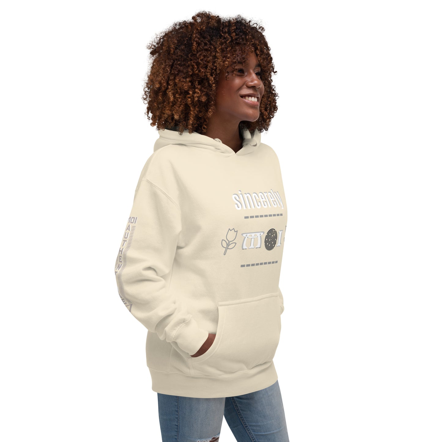Side view of a woman wearing a beige unisex hoodie with a front pouch pocket, standing against a white background.