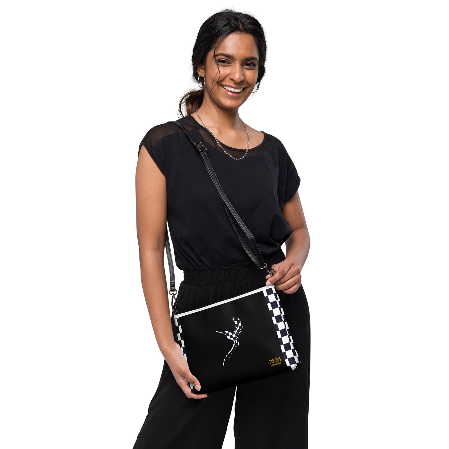 A woman wearing a black chequered cross-body bag
