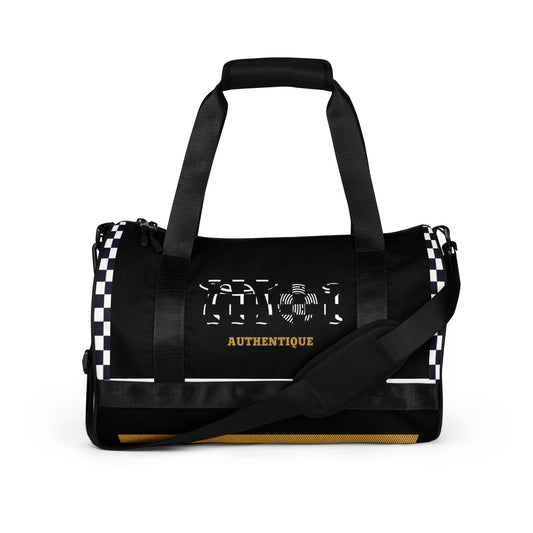 A two-tone, ska-inspired black and yellow gym duffel bag featuring checkered design details and the brand name 'Moi Authentique' displayed prominently.