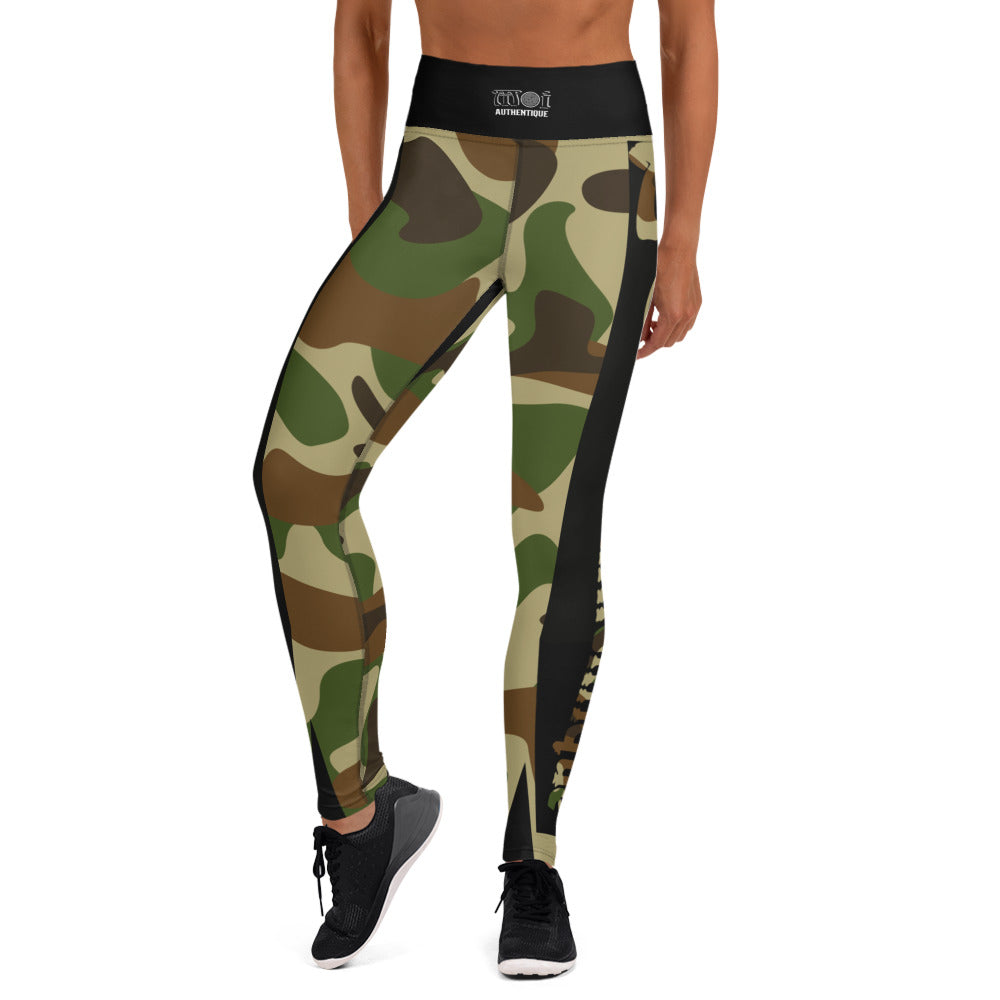 A person in a yoga pose wearing camouflage-patterned yoga leggings.