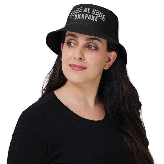 A woman wearing a black Al Skapone embroidered bucket hat with a vintage ska and two-tone music style logo.
