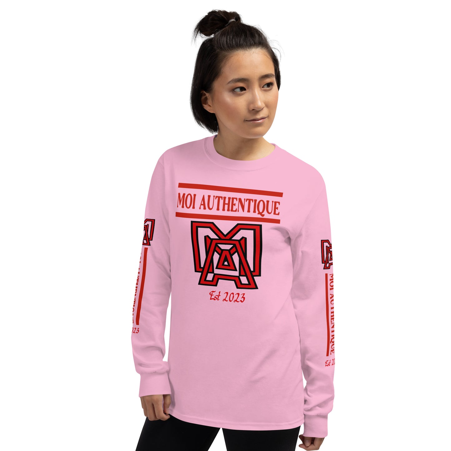 Side-on view of a woman wearing a long-sleeved pink shirt with red text and graphics, including the brand name 'Moi Authentique' across the chest