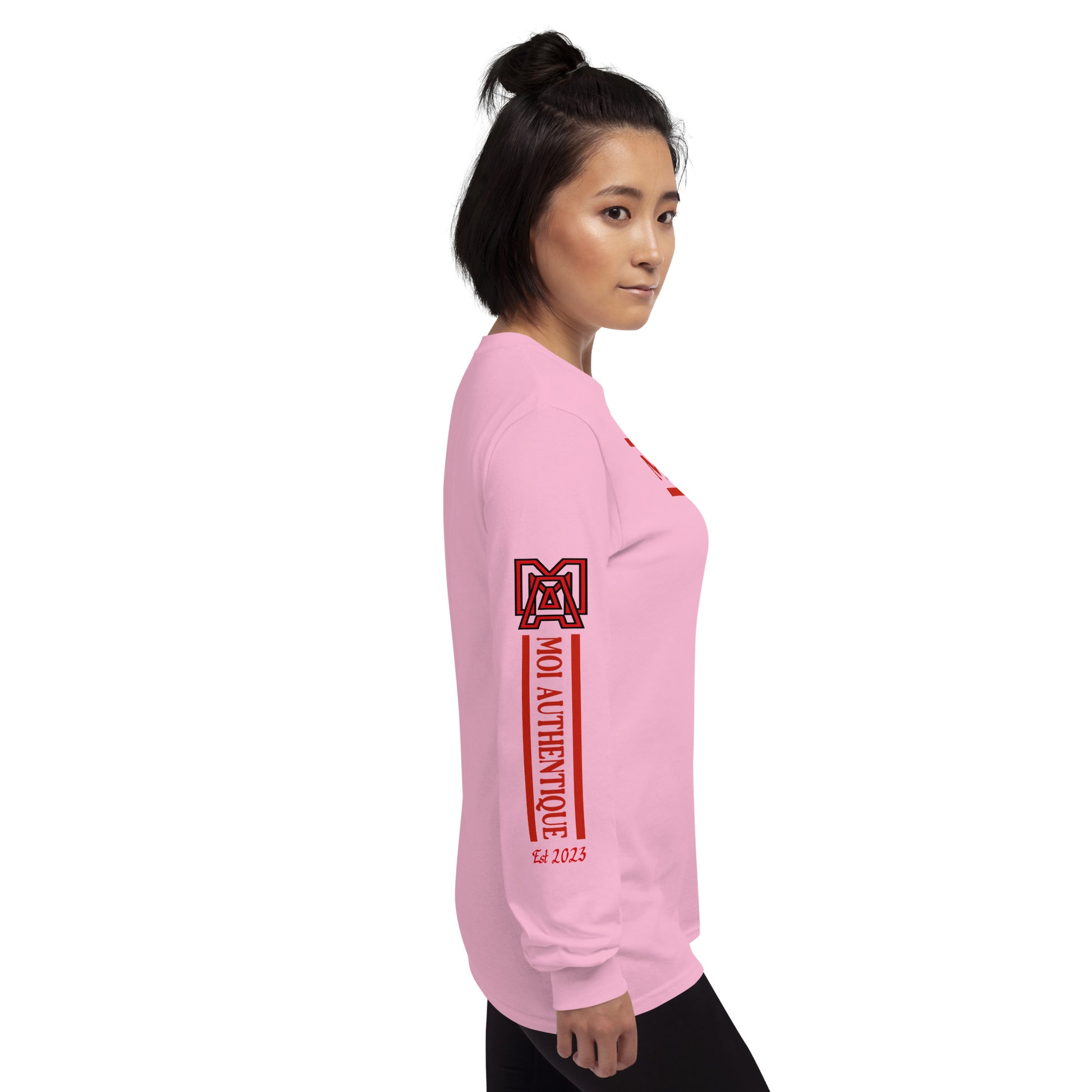 Right side view of a woman wearing a long-sleeved pink shirt with red text and graphics, including the brand name 'Moi Authentique' across the chest
