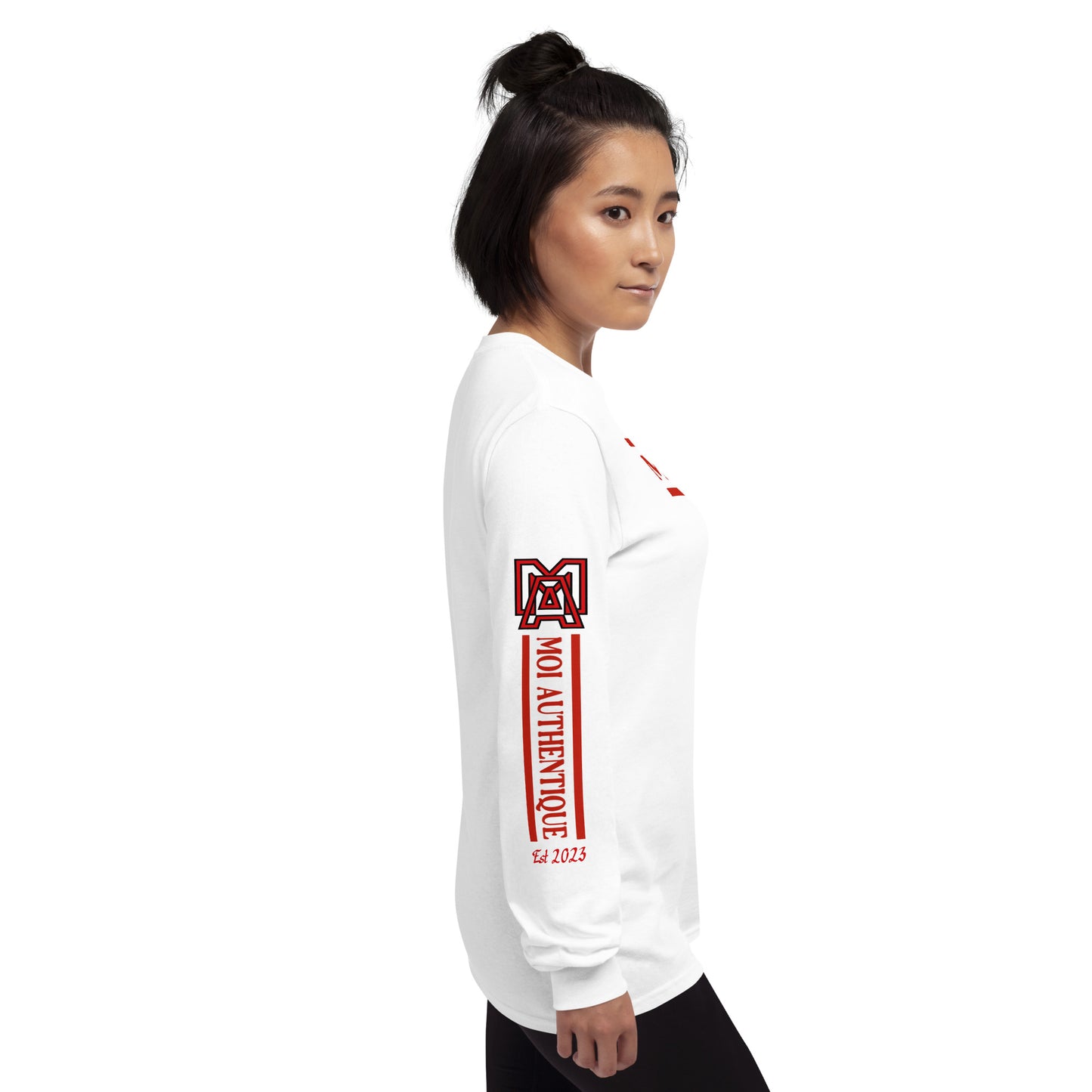 Right side view of a woman wearing a long-sleeved white shirt with text and logos on it, standing against a plain background.
