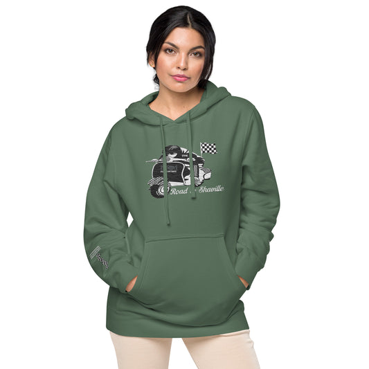 A person wearing a green pigment-dyed hoodie with front and sleeve embroidery featuring a vintage moped design and the text 'Road to Skaville'.