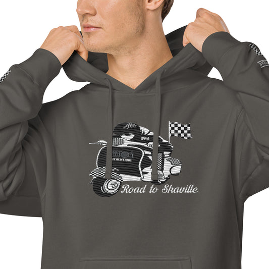 A male model wearing a grey unisex pigment-dyed hoodie with front and sleeve embroidery, featuring a vintage Lambretta design.