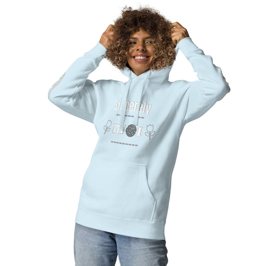 A woman wearing a light blue unisex hoodie with a front pouch pocket and drawstrings, standing against a white background.