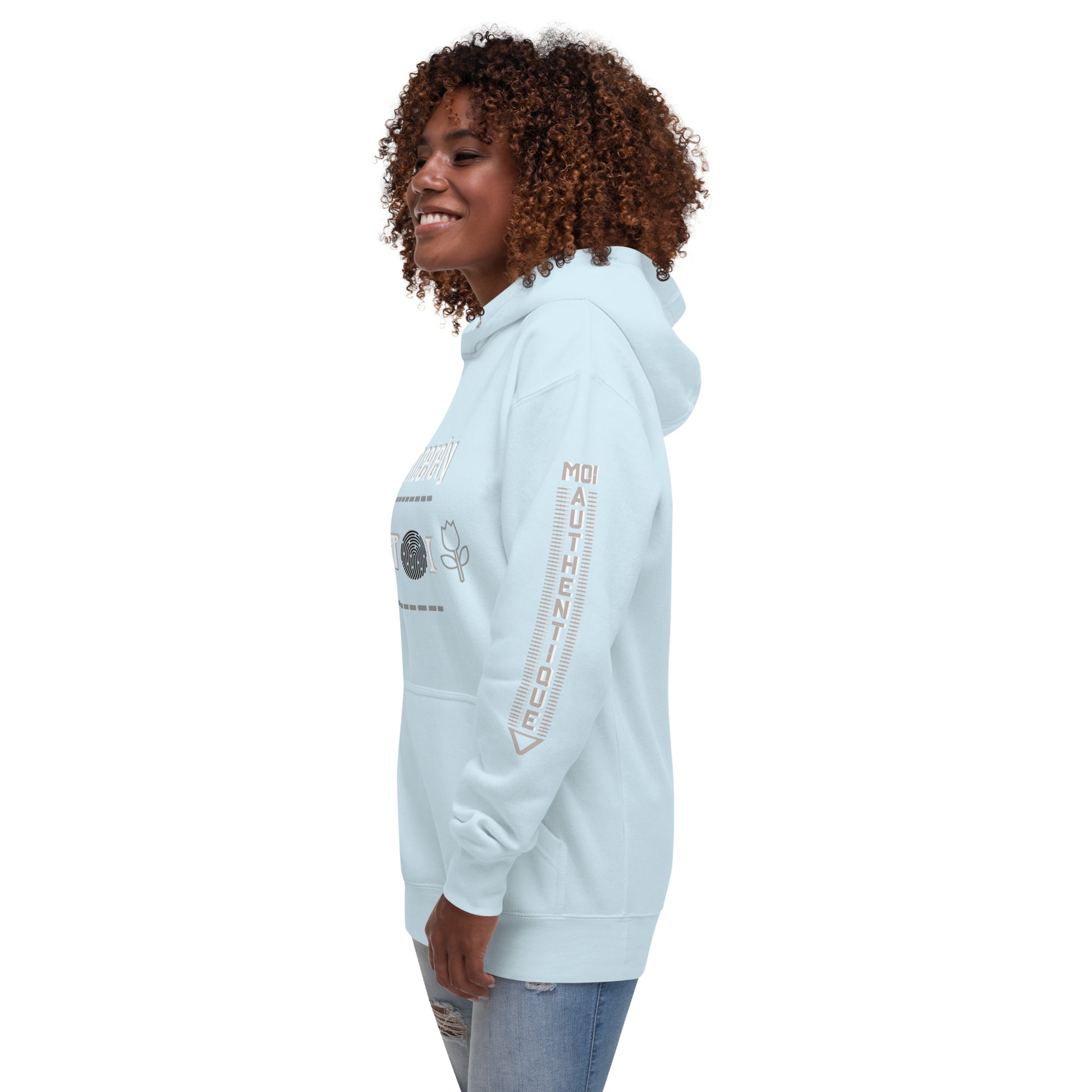 Side view of a woman wearing a light blue unisex hoodie with a front pouch pocket and drawstrings, standing against a white background.